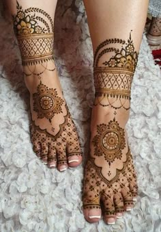 the feet are decorated with henna designs