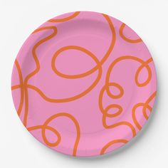 a pink and orange plate with an abstract design on the bottom, in front of a white background