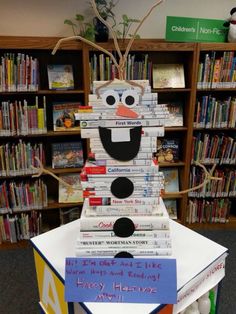 a stack of books with a snowman made out of them