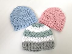 three crocheted hats sitting next to each other