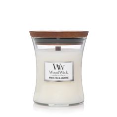 woodwick white tea and burnings candle with wooden lid in clear glass container on white background