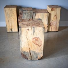 four pieces of wood sitting on top of a cement floor