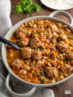 a white bowl filled with meat and beans