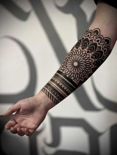 a person's arm with a tattoo on it and a flower design on the wrist