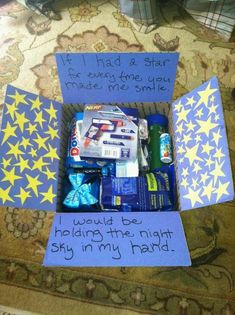 an open box filled with candy and some writing on the inside, sitting on top of a rug