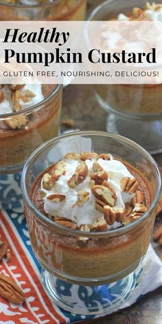 healthy pumpkin custard dessert in glass bowls with whipped cream and pecans on top