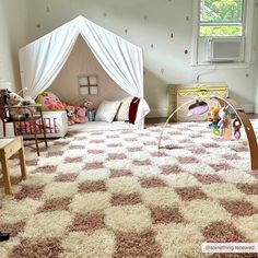 a child's bedroom with pink and white rugs on the floor, furniture and decor