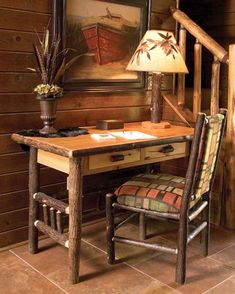 a wooden desk with a chair and lamp