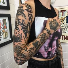 a woman with many tattoos on her arm