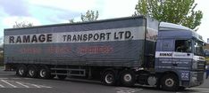 a large transport truck driving down a street