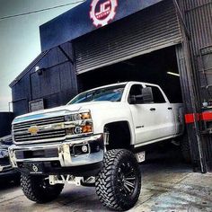 a white truck parked in front of a building