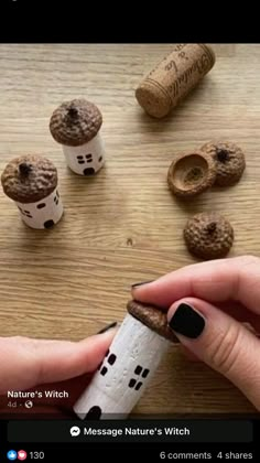 someone is holding a cork with some little houses on it