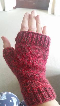 a person wearing a red knitted arm warmer