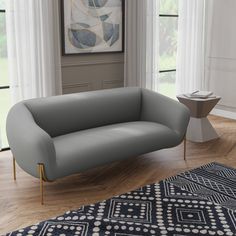 a gray couch sitting on top of a wooden floor