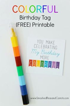 a colorful birthday tag is next to a crayon marker