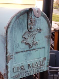 an old mailbox with the us mail logo painted on it