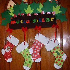 christmas stockings are hanging on the front door with name written in black and red letters