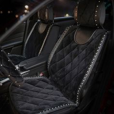 the interior of a car with black leather and studded trimmings on it