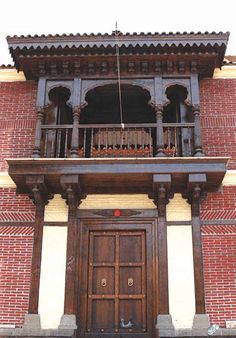 an old building with a wooden door and balcony