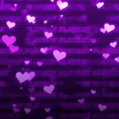 purple hearts floating in the air with words written on them and some pink lights behind it