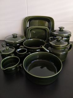 a table topped with lots of green dishes