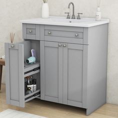 a bathroom sink sitting under a mirror next to a cabinet