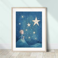 a little boy is sitting on top of a hill looking at the stars