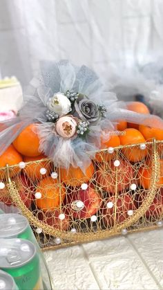 a basket filled with lots of oranges on top of a table