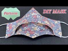 a cloth mask with flowers on it and the words pattern diy mask written below