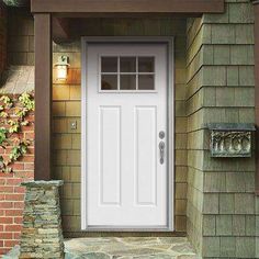 a white front door on a brick house