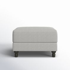 a small footstool sitting on top of a white floor