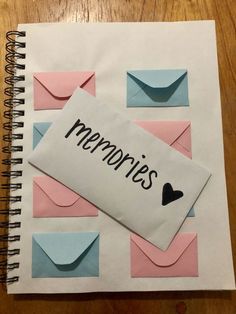 a notepad with the word memories written on it next to an envelope and heart