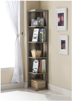 a book shelf with books on it in front of a window and pictures hanging on the wall