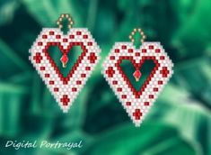 two red and white heart shaped earrings on a green leafy background with the words digital portrait