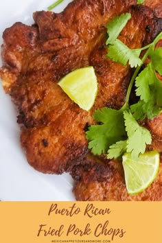 fried pork chops with cilantro and lime garnish on a white plate