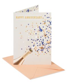 a happy anniversary card with confetti and champagne bottle