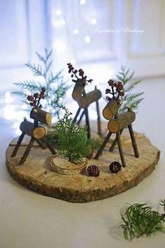 an image of christmas decorations made out of wood and pine cones on a wooden tray