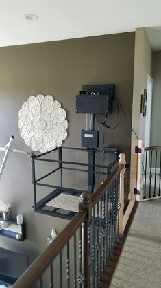 there is a white flower on the wall in this living room with metal railings