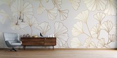 a chair and table in front of a wall with gold leaf designs on the walls