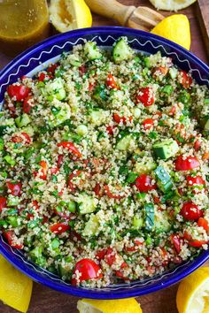 a blue bowl filled with couscous and vegetables