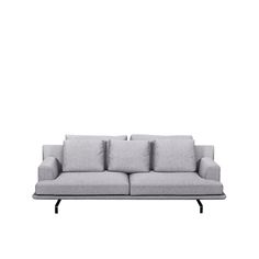 a gray couch sitting on top of a white floor