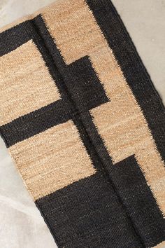 a black and tan rug on the ground