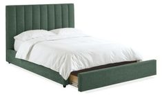 a bed with a green headboard and white sheets on it's side, in front of a white background