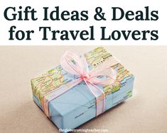 a wrapped gift box with a pink bow and map in the background text reads, gift ideas & deals for travel lovers