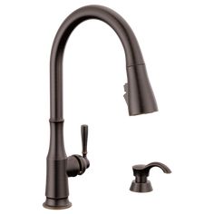 an image of a kitchen faucet with two handles and one side sprayer