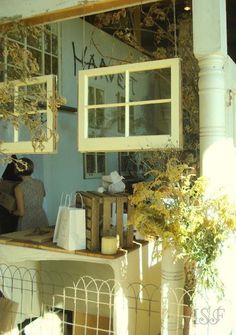 a woman sitting on a bench in front of a window