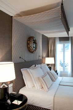 a bedroom with a large bed and two lamps on either side of the headboard