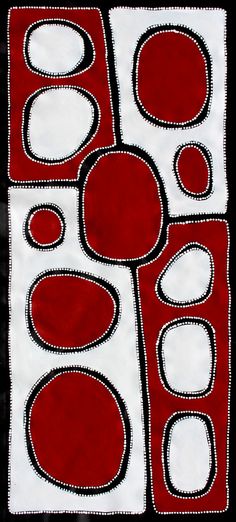 a red and white quilt with circles on it