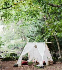 a tent set up in the middle of a forest