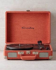 an orange suitcase with a record player inside